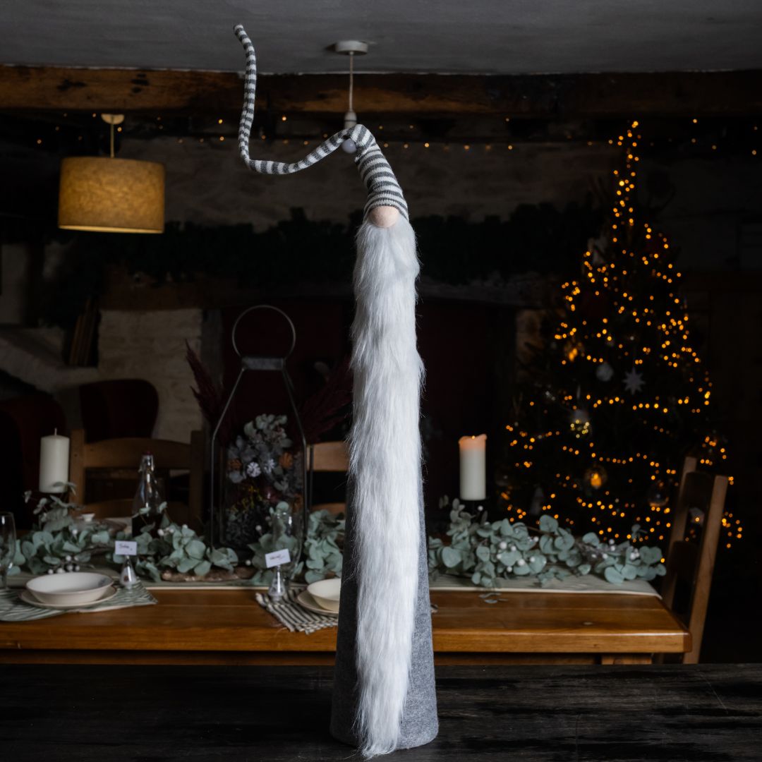 Tall grey stripe fabric gonk on island unit against Christmas background