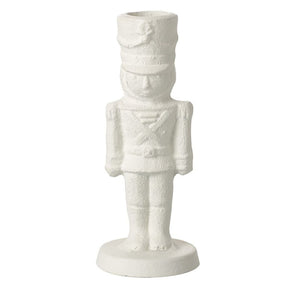 A picture of the white cast iron Christmas nutcracker soldier standing to attention on a plinth.  There's a hole in the top for a dinner candle