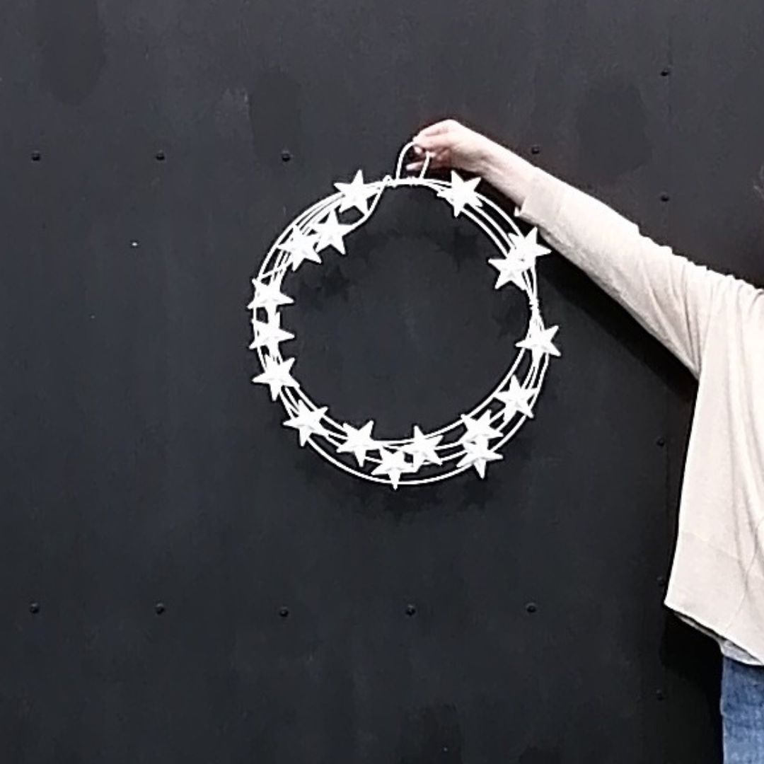 Model showing the size of the white star metal wreath against a black background