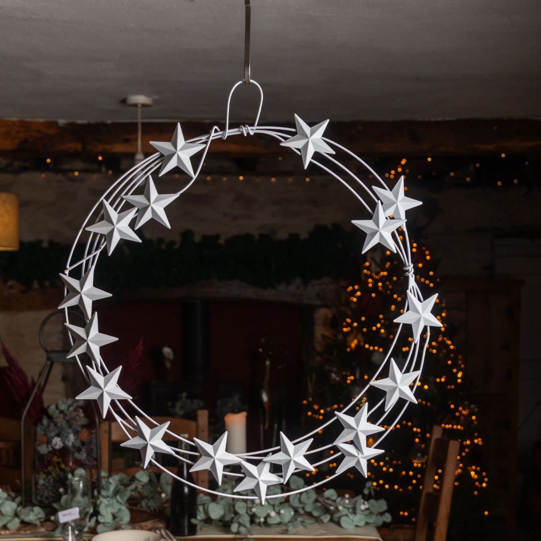 Decorative metal wreath with stars hanging indoors