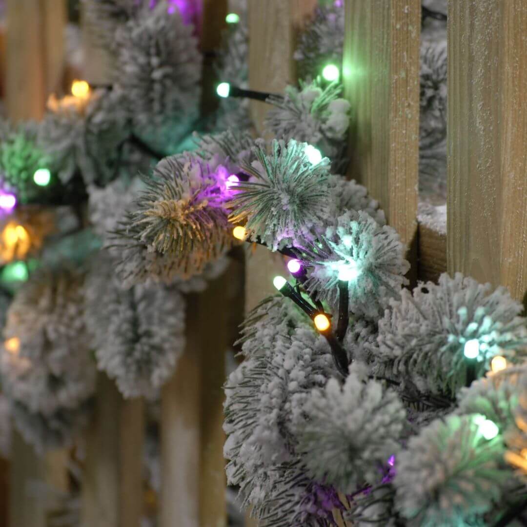 Showing the 1000 pastel tree lights on a garland on a fence