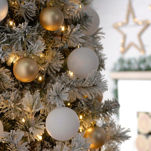On the flocked decorated Christmas tree is the 200 Warm White LED String Lights