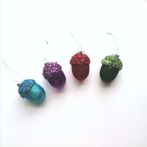 Selection of acorn Christmas tree decorations in turquoise, purple, red and green