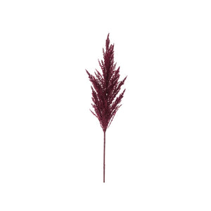 Burgundy stem of artificial pampas grass photographed against a white background