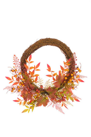 Half decorated autumn berry wreath with the top of the vine exposed.  Autumnal berries and leaves decorate the bottom half of the wreath