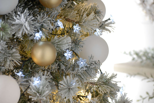Battery snowflake Christmas lights on a decorated flocked Christmas tree