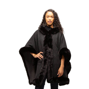 Black faux fur lined poncho with hood as worn on a model