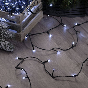The 1000 cold white LED string Christmas lights set being untangled on the floor