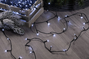 Box of 360 cold white LED string Christmas lights being unravelled on a floor
