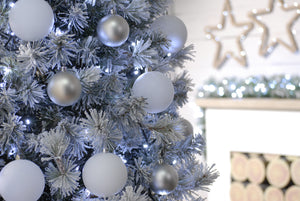 Cold white LED string lights on a decorated flocked Christmas tree with silver Christmas baubles