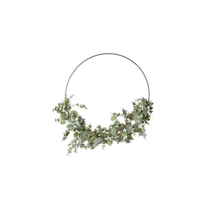 Based on a simple metal hoop, there's different varieties of eucalyptus bundled together on the bottom half of the hoop to make this faux eucalyptus wreath 