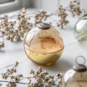 Glass bauble in gold on the table