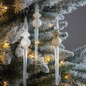Glass finial Christmas ornaments on a flocked tree