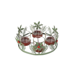 Showing the holly tea light candle holder with the clumps of metal berry and holly fir clusters sitting around the edge of the 4 glass beakers for the tea lights