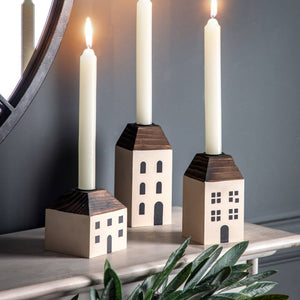 House candle holders with dinner candles in them