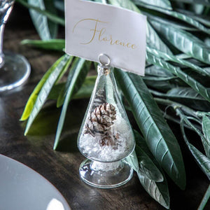 Showing how to use the mini tabletop Christmas tree as a name card holder on the dining table