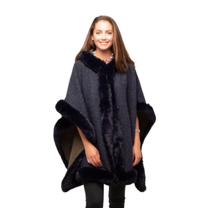 Navy blue fur lined poncho with hood as worn on a model