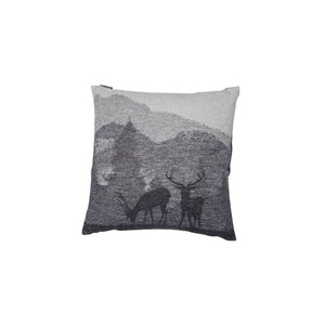 Pair of stag cushion in front of a mountain scene