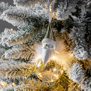 The Santa Claus Christmas tree ornament on a flocked tree