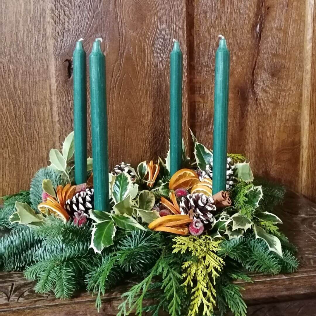 A foliage table centrepiece with green candles