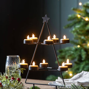 tealights all lit on the christmas tree candle holder