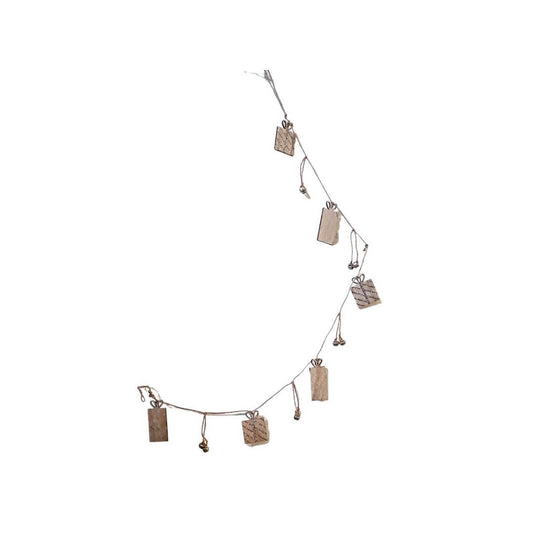 Showing the wooden presents with the silver detailing and the silver sleigh bells pair in between the presents.  The garland is tied on via brown string