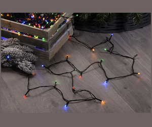 Set of 600 multi colour LED string Christmas lights being untangled underneath the Christmas tree